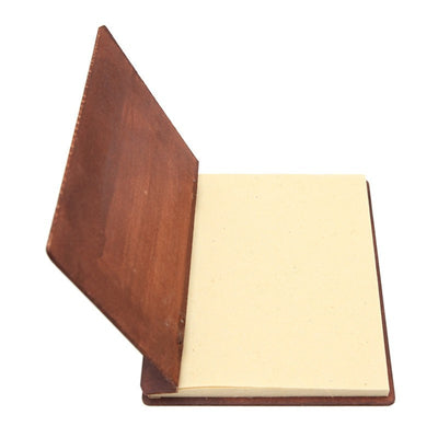 hardboard backed plain note book open showing recycled paper pages