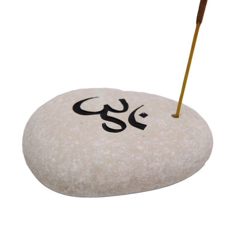 Stone incense holder with Om carved into top and painted and small hold drilled to one side to hold an incense stick 