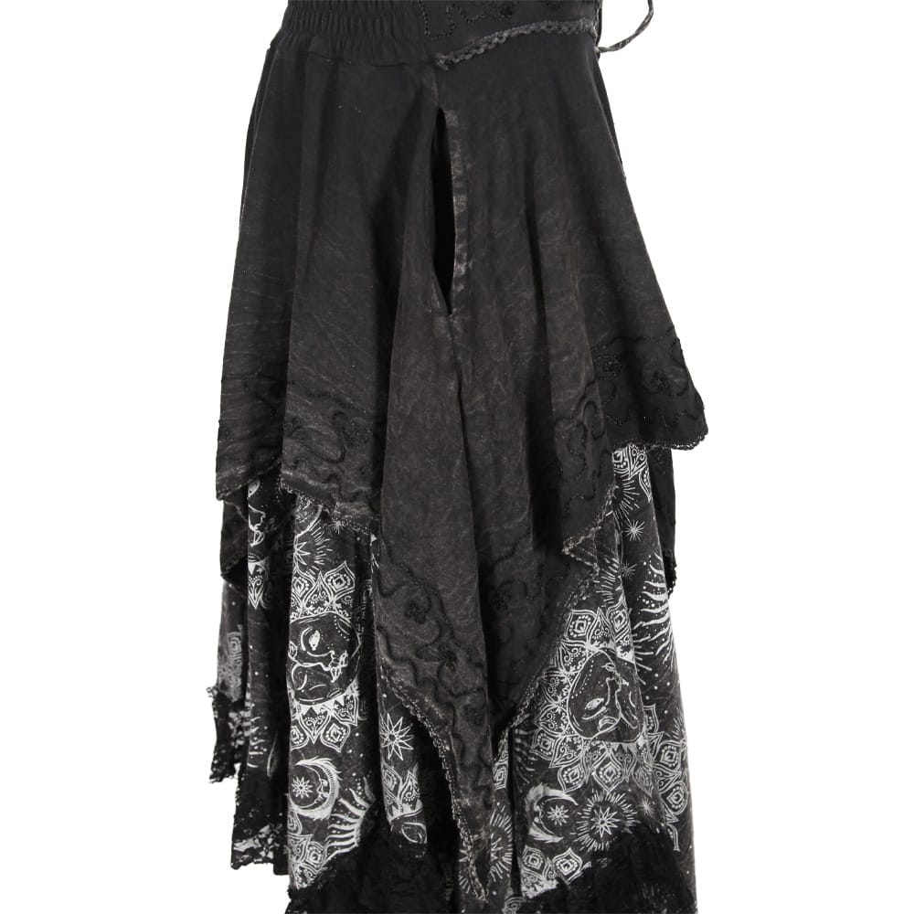 A black gothic-style layered skirt featuring sheer lace panels with white skull and floral patterns, a split front slit, and a drawstring waistband, shown against a plain white background.