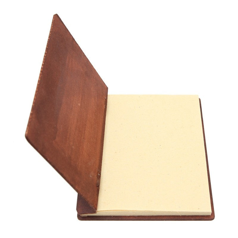hardboard backed plain note book open showing recycled paper pages