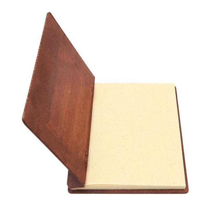 hardboard backed plain note book open showing recycled paper pages