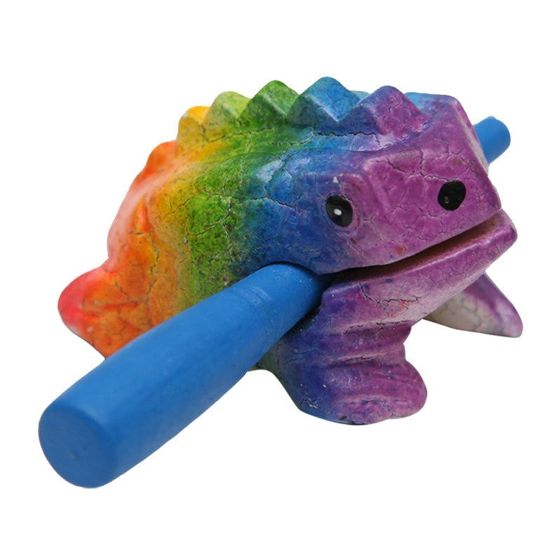A small rainbow wooden frog with a stick and notches on its back