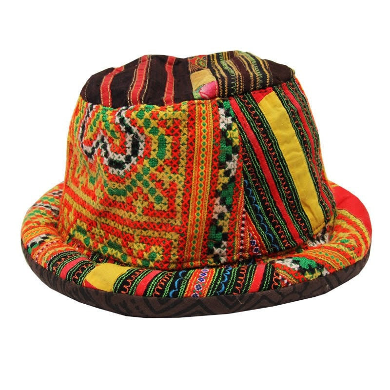 Rolled brim trilby style hat in traditional Thai Hill Tribe material, patterned and striped in different oranges, greens, yellows and browns. 